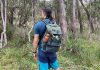 Man wearing backpack in forest