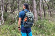 Man wearing backpack in forest